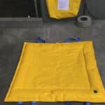 Weighted containment boom is made of heavy duty PVC wrapped in geotextile for good ground connection. Each boom has a cuff so multiple containment booms can be joined together. Comes with handles for easy handling. weighted drain cover deployed over a stormwater drain to keep liquids from entering