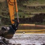 Chatoyer silt curtain in situ during excavation for bridge construction in a waterway for construction site sediment control Chatoyer silt curtain in situ during excavation for bridge construction in a waterway for construction site sediment control