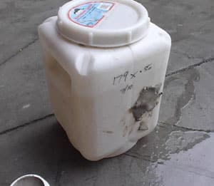 StopLeak-used-on-Leaking-Container SpilMax StopLeak repair putty has been applied to stop a leak through a punture on a plastic container
