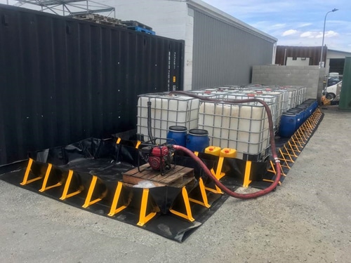 Portable Containment Bunds made from black XR5 used to store liquids in drums and IBCs and bund a pump