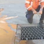 Man using DrainSAFE handle to close the DrainSAFE valve and isolate the drain pit to contain a spill